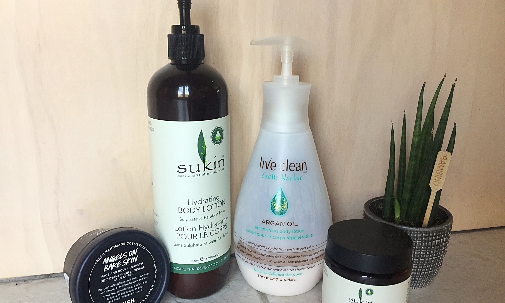 An image of a selection of non-toxic body and face care products, including brands such as Sukin, Live Clean, and Lush.